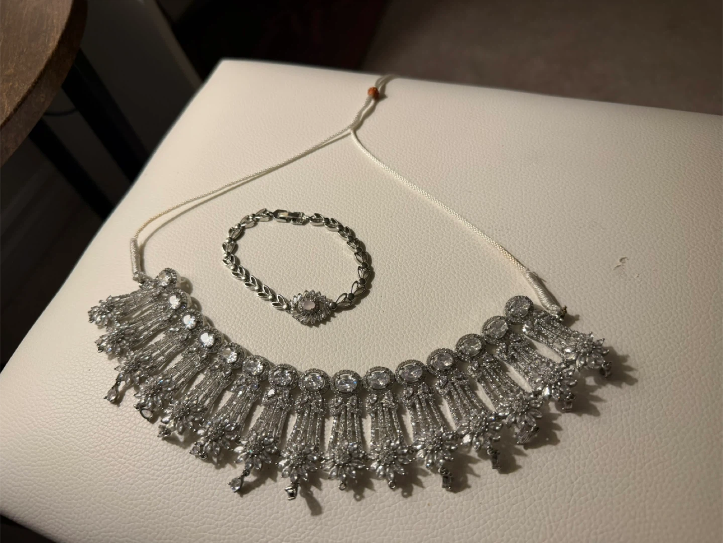 Silver coloured necklace and bracelet set with rhinestones