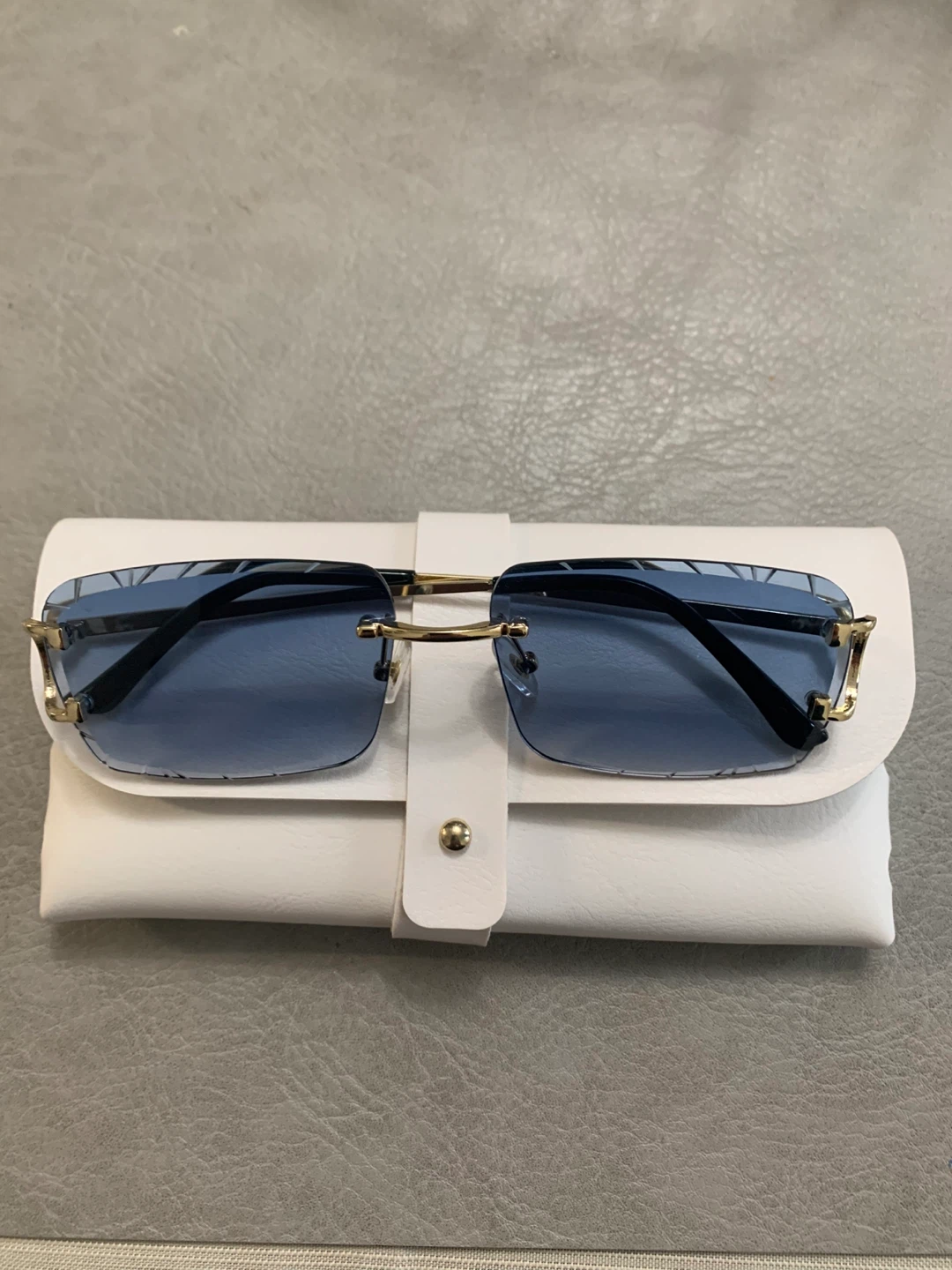 Rimless Blue Lens Sunglasses with Gold Accents