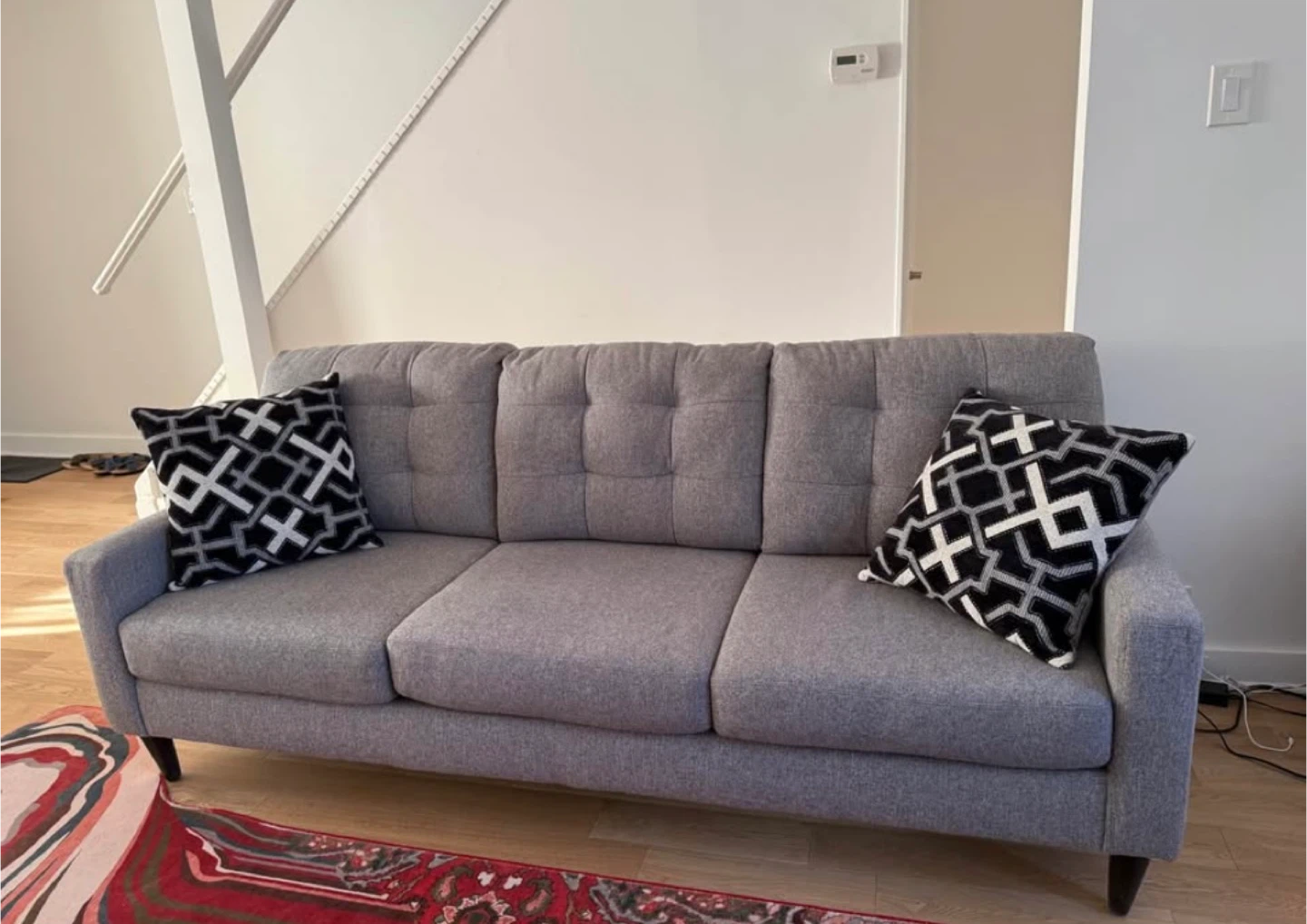 Grey Tufted Sofa with Geometric Pillows