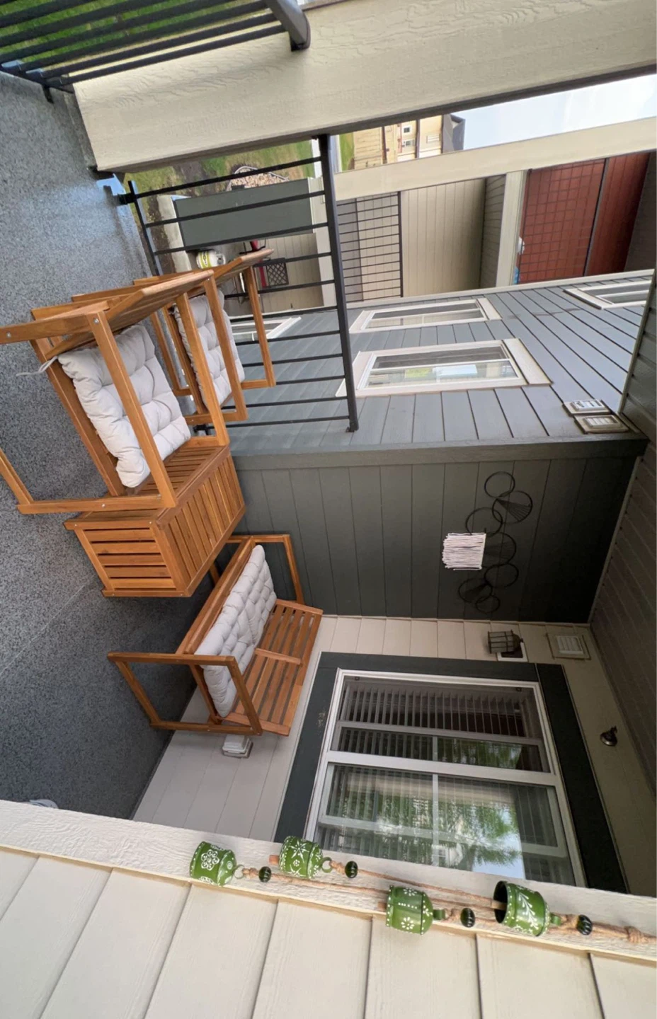Wooden porch swing with cushions