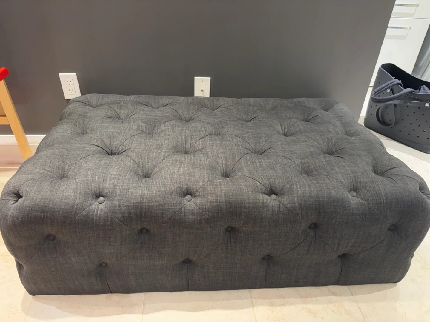 Dark grey tufted ottoman
