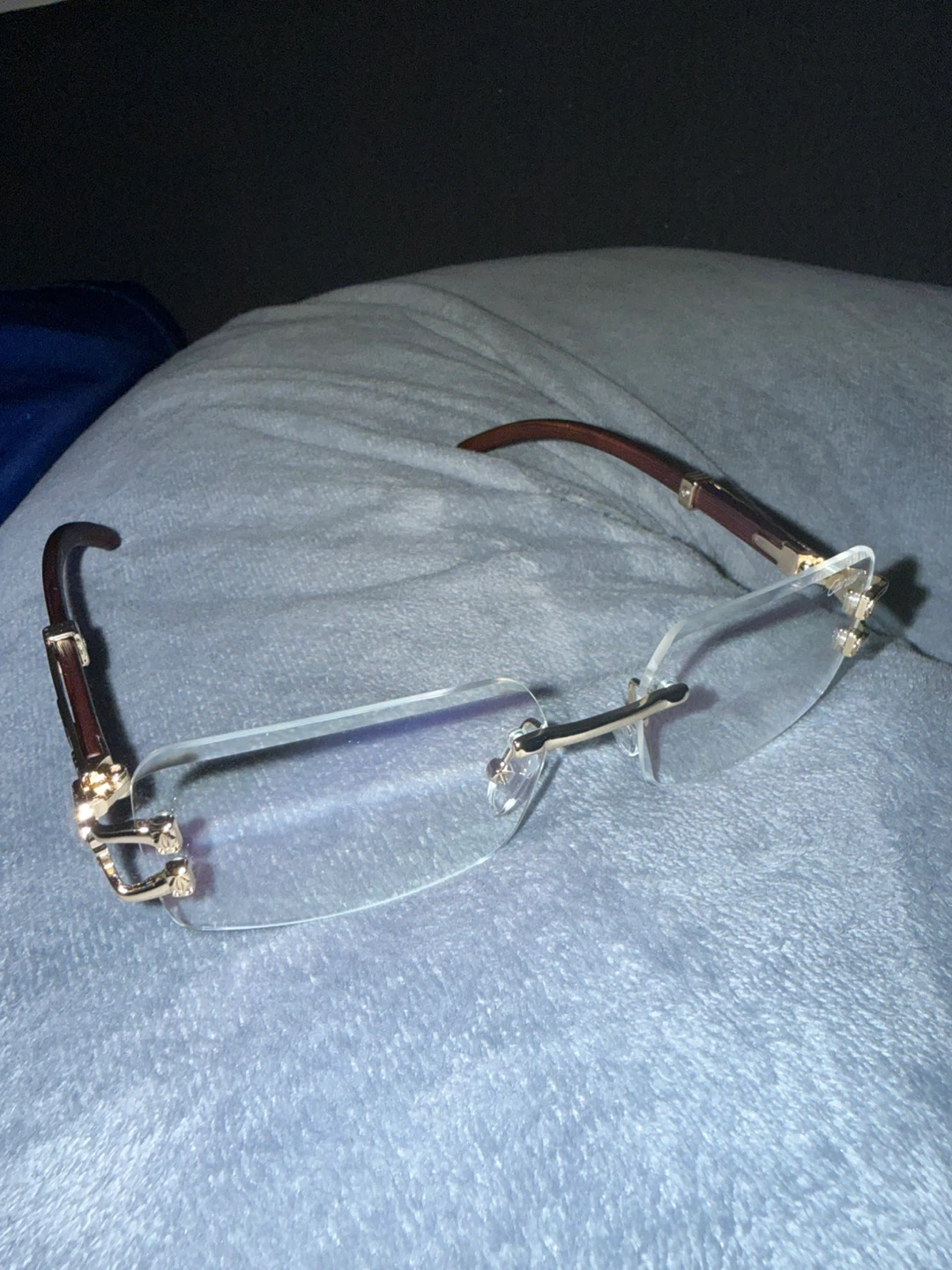 Rimless Eyeglasses with Gold Accents and Wood Arms