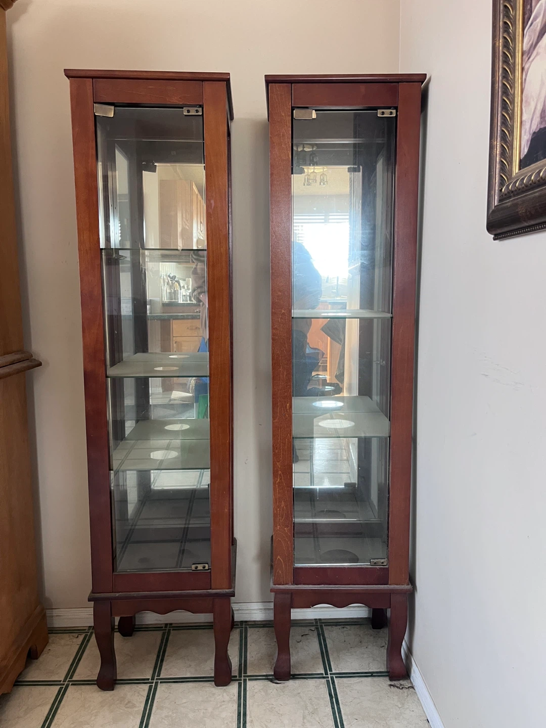 Two wooden antique curio cabinets with glass doors
