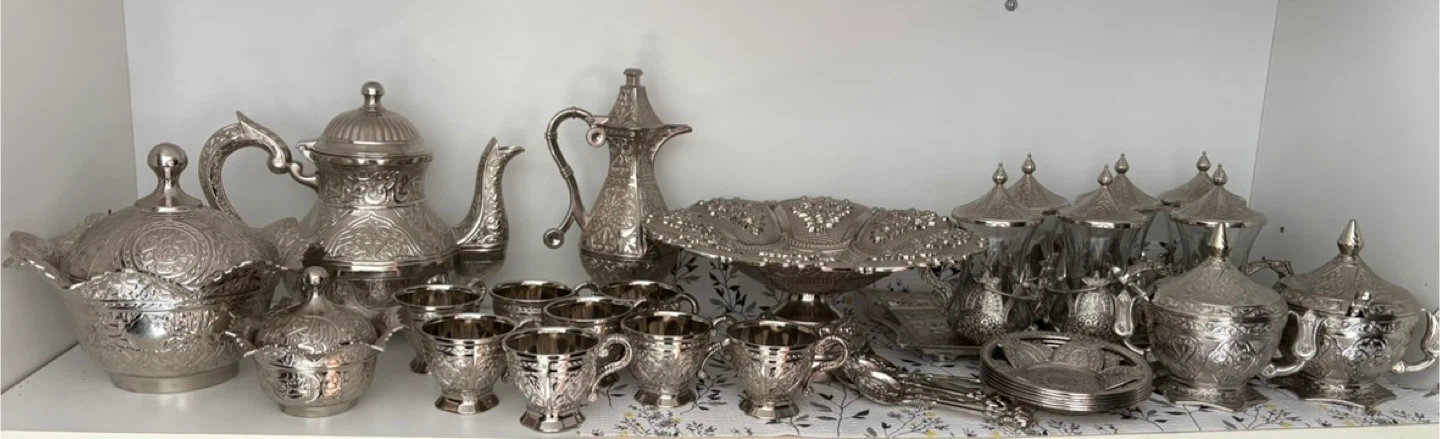 Set of ornate silver-coloured tea service and serving dishes