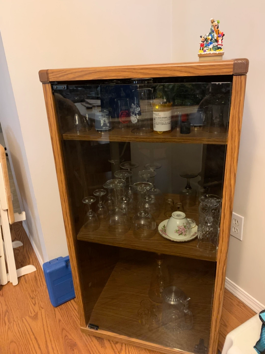 Wooden cabinet with glass door and shelves for viewing