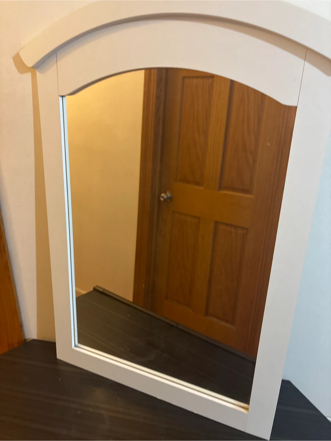 White bedroom mirror has wire for hanging