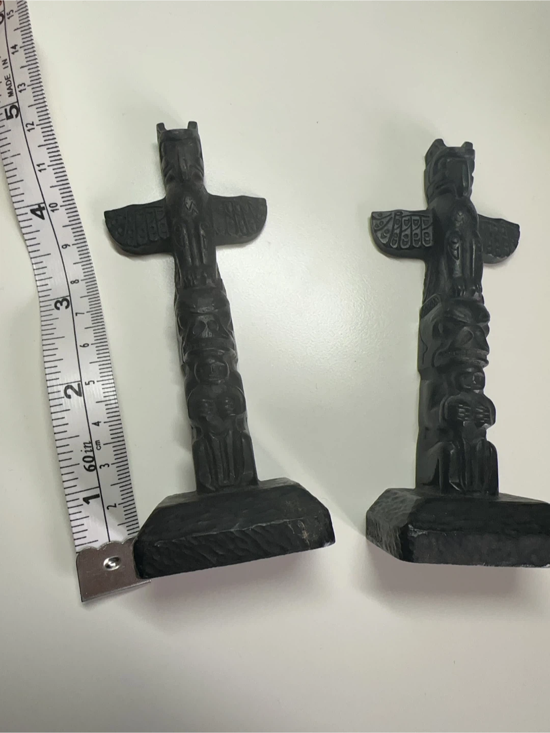 Two Black Wooden Totem Pole Figurines