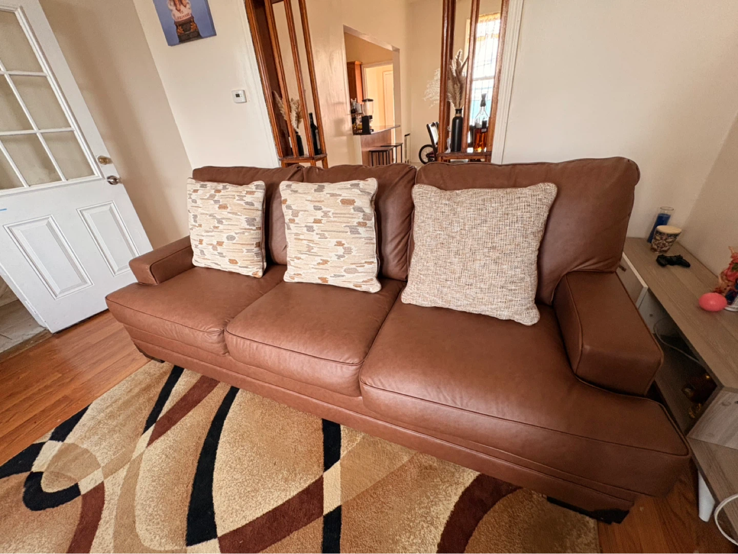 Brown Leather Sofa with Throw Pillows