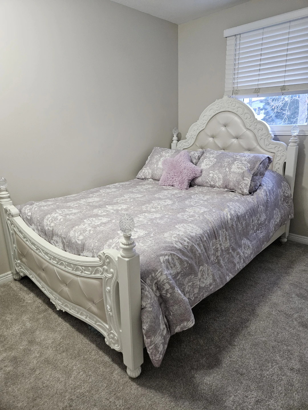 White upholstered bed with ornate detailing