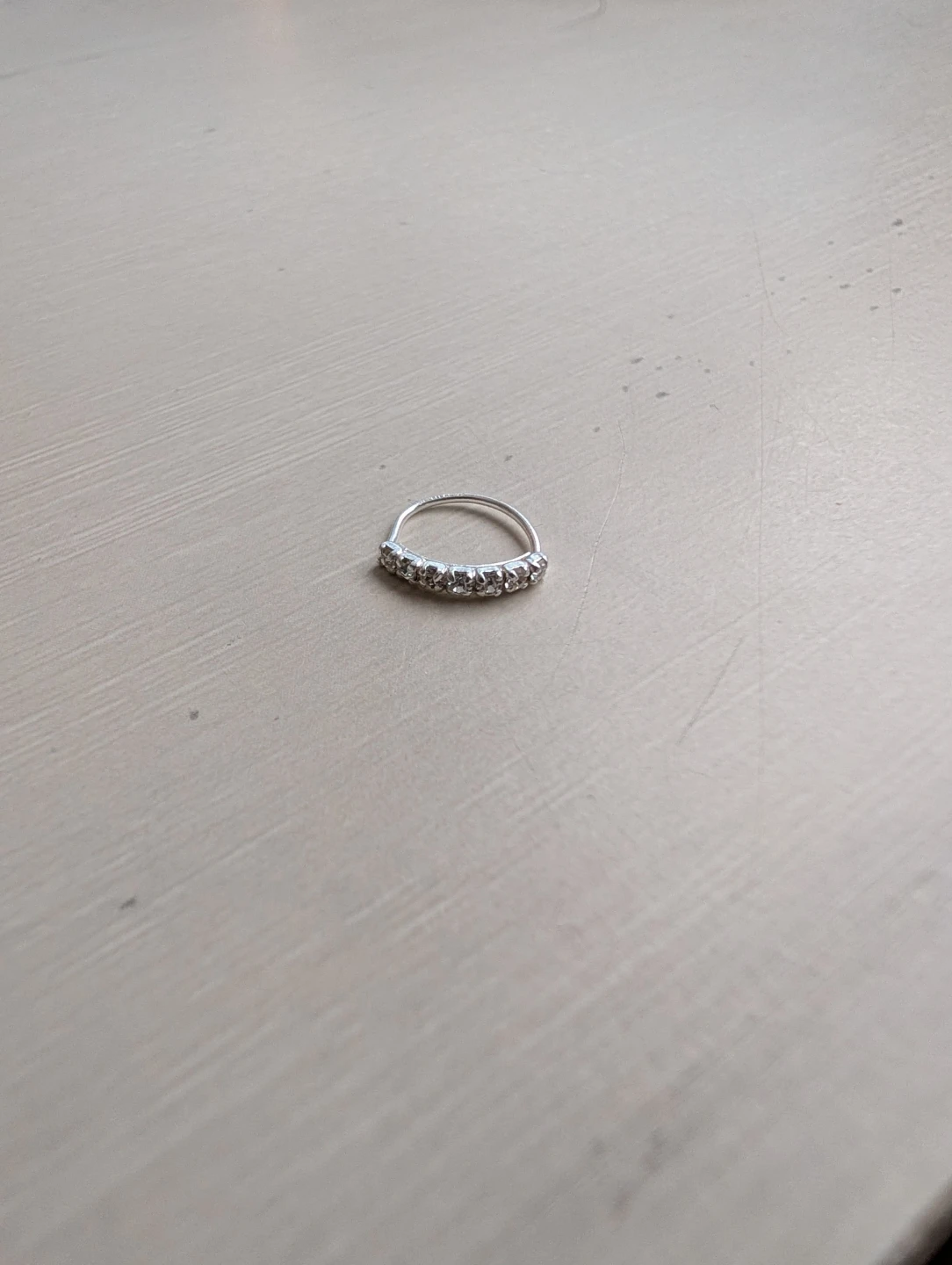 Silver coloured ring with rhinestones