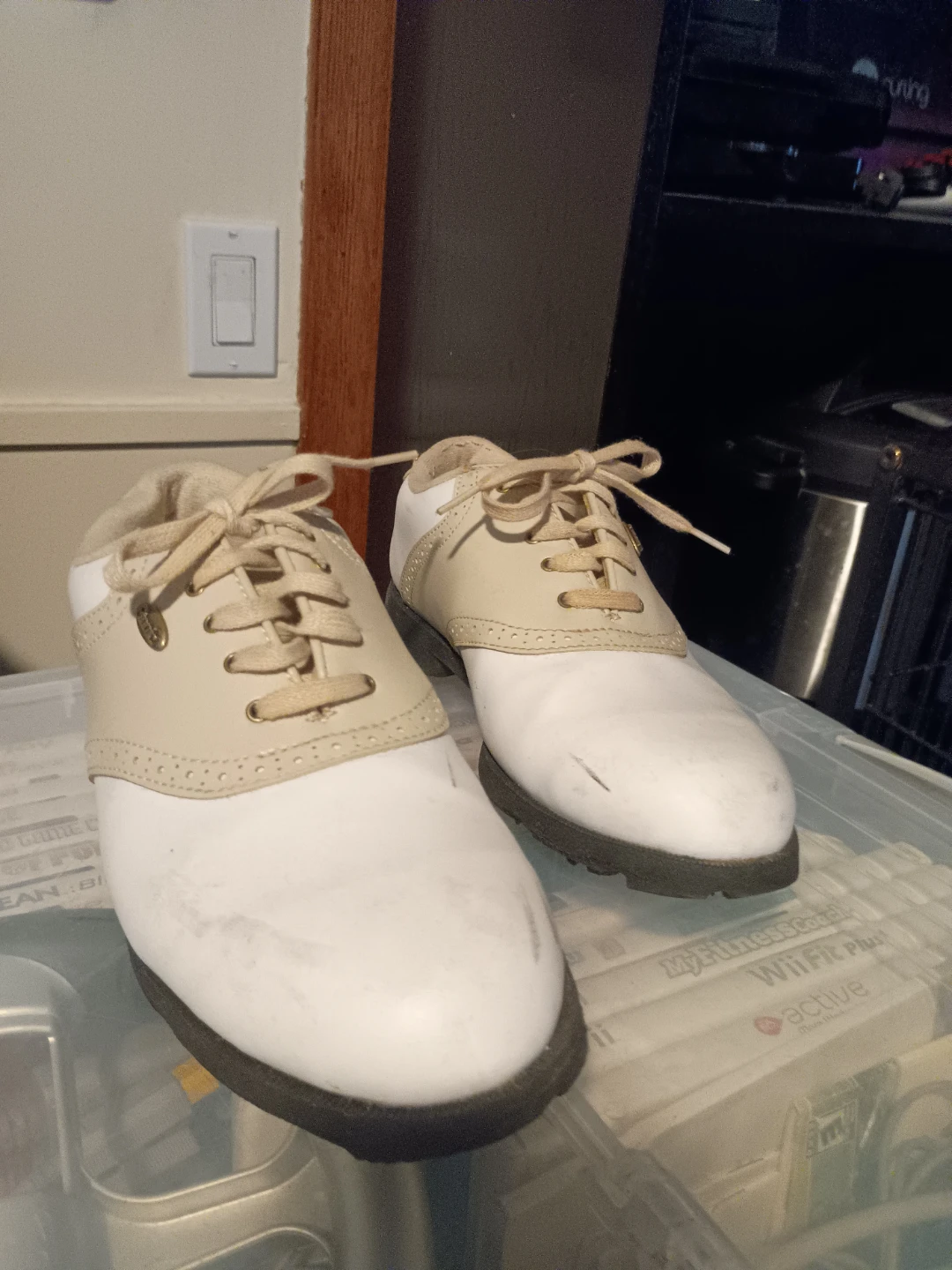 White and tan golf shoes
