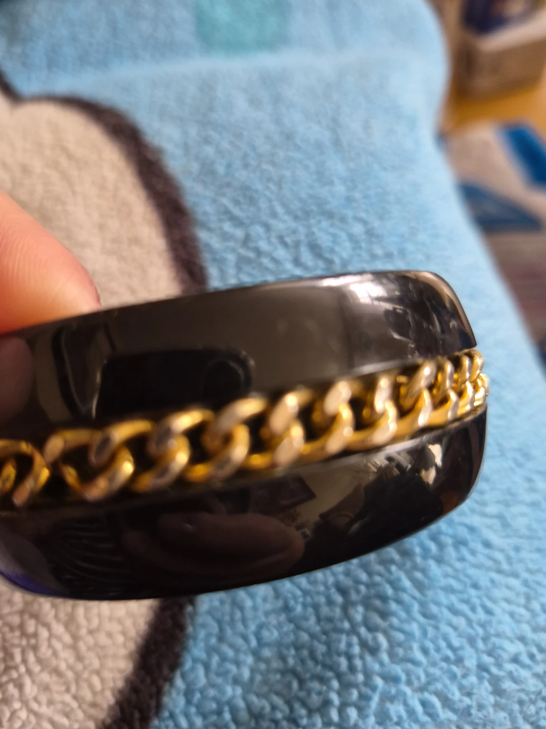 Black bangle with gold chain detail