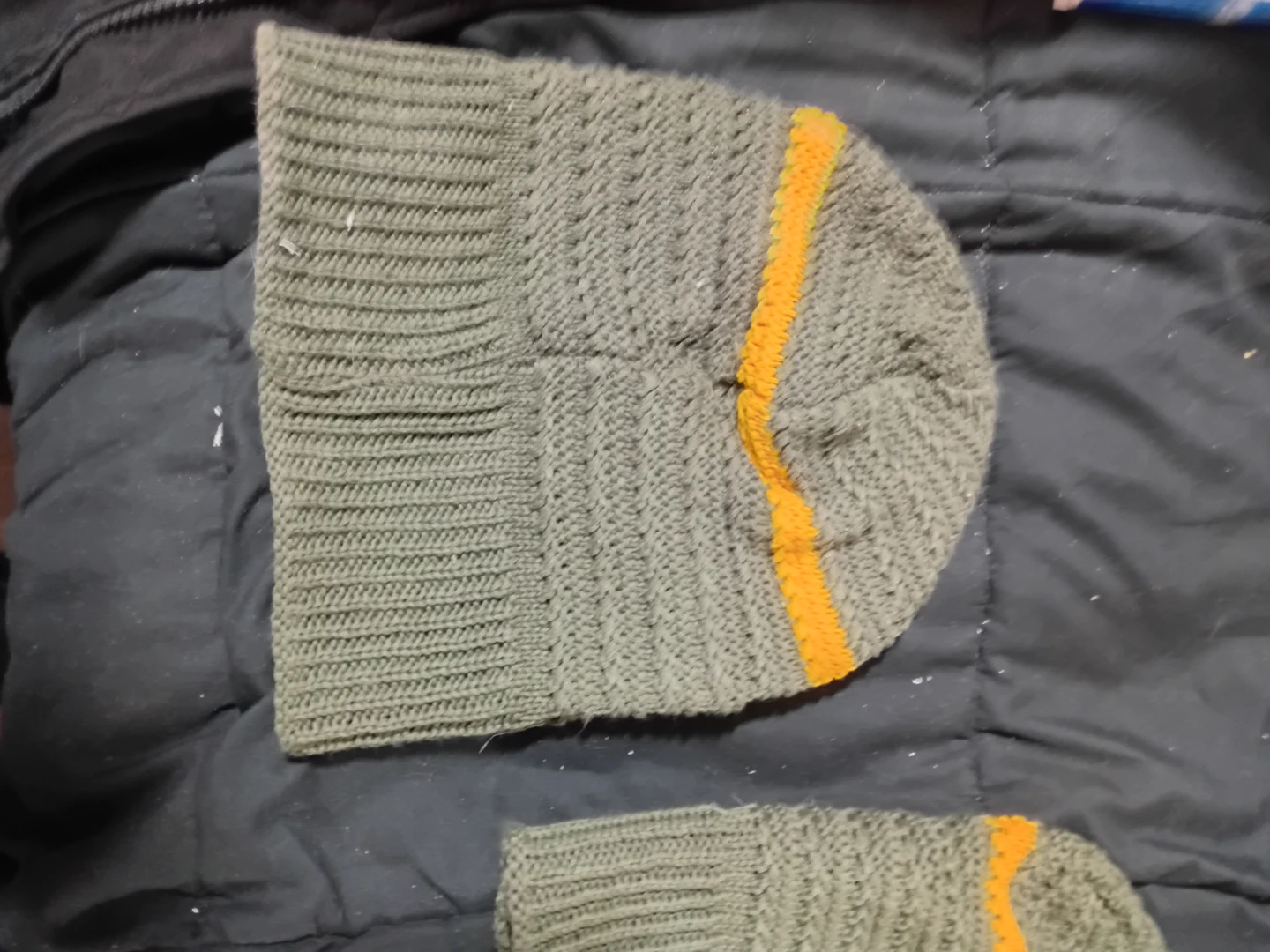Green knit beanie with orange stripe