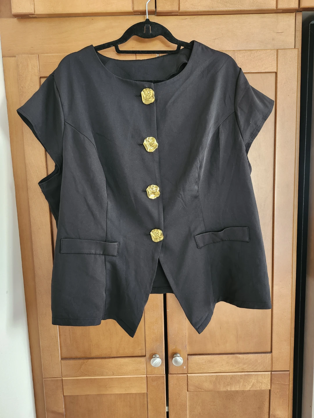 Black vest with gold buttons