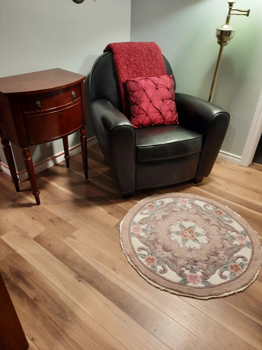 Black Armchair with Decorative Pillow and Red Throw!
