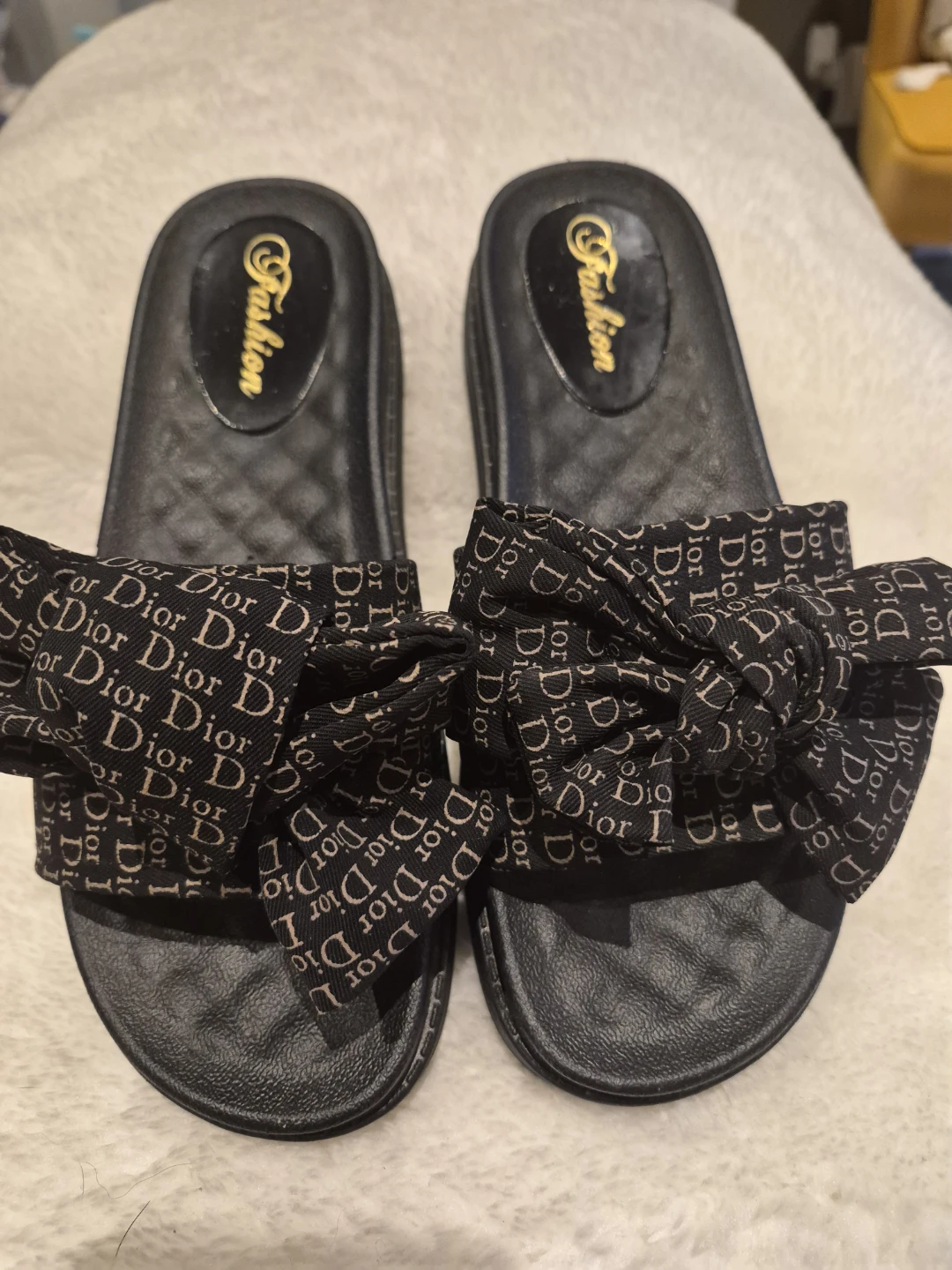 Black slides with Dior pattern bow