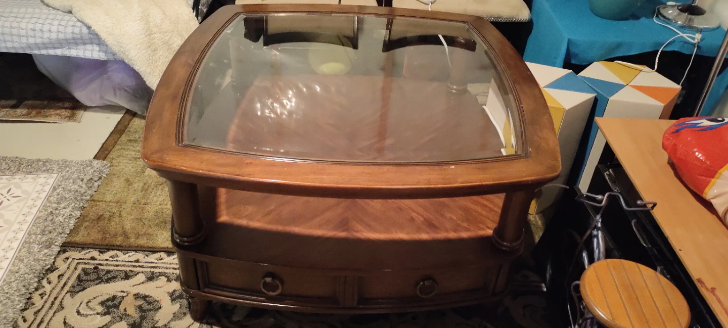 Wood coffee table with glass top and drawers
