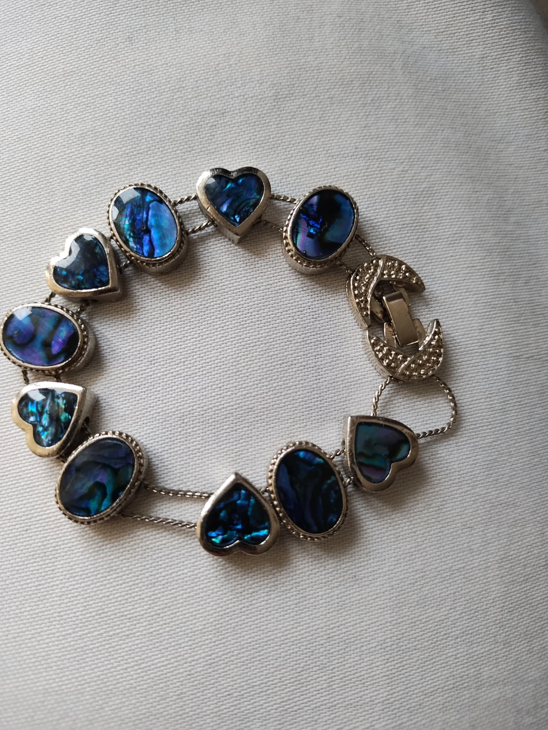 Silver tone bracelet with abalone shell hearts and ovals