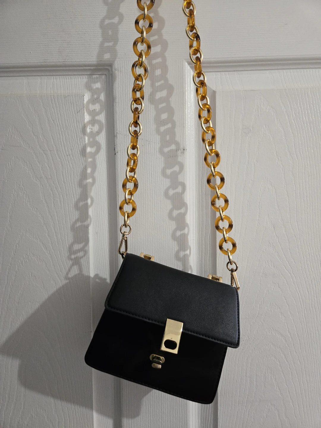Black purse with tortoise shell chain strap from topshop