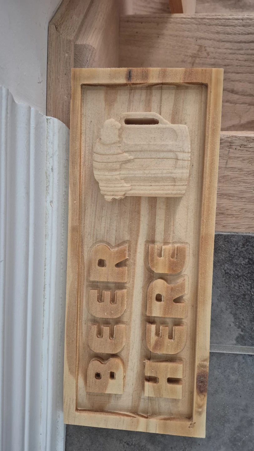 carved "Beer Here" wooden sign