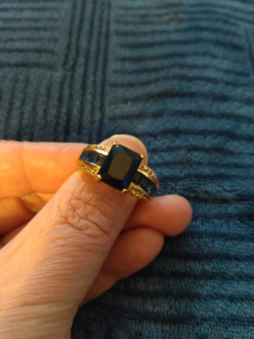 Gold-tone ring with deep blue rectangular stone