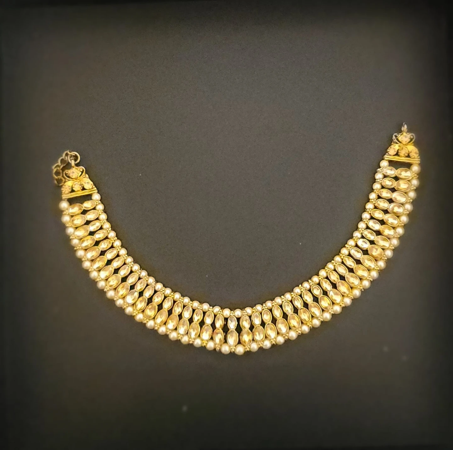 Gold-toned hair accessory with pearls and clear stones