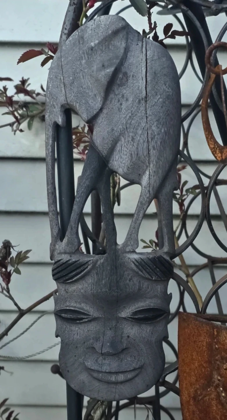 Carved wooden elephant and mask wall hanging