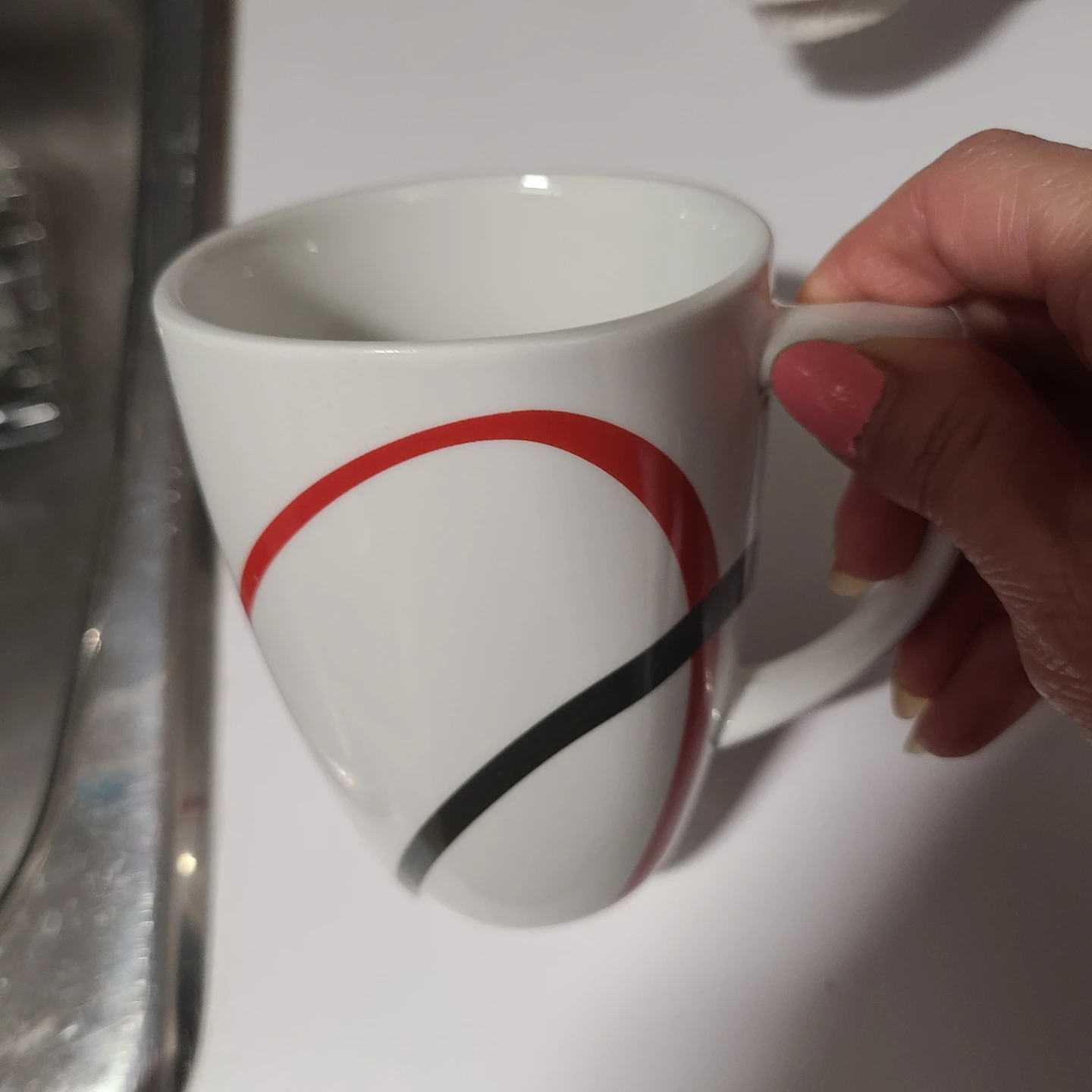 White Mug with Red and Black Swirl Design