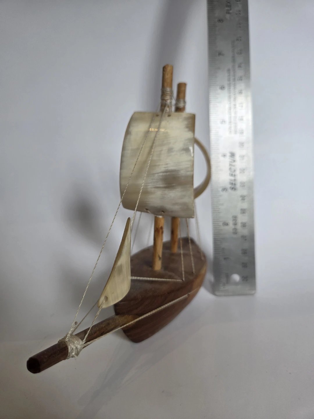 Folk art sailing boat with horn sails
