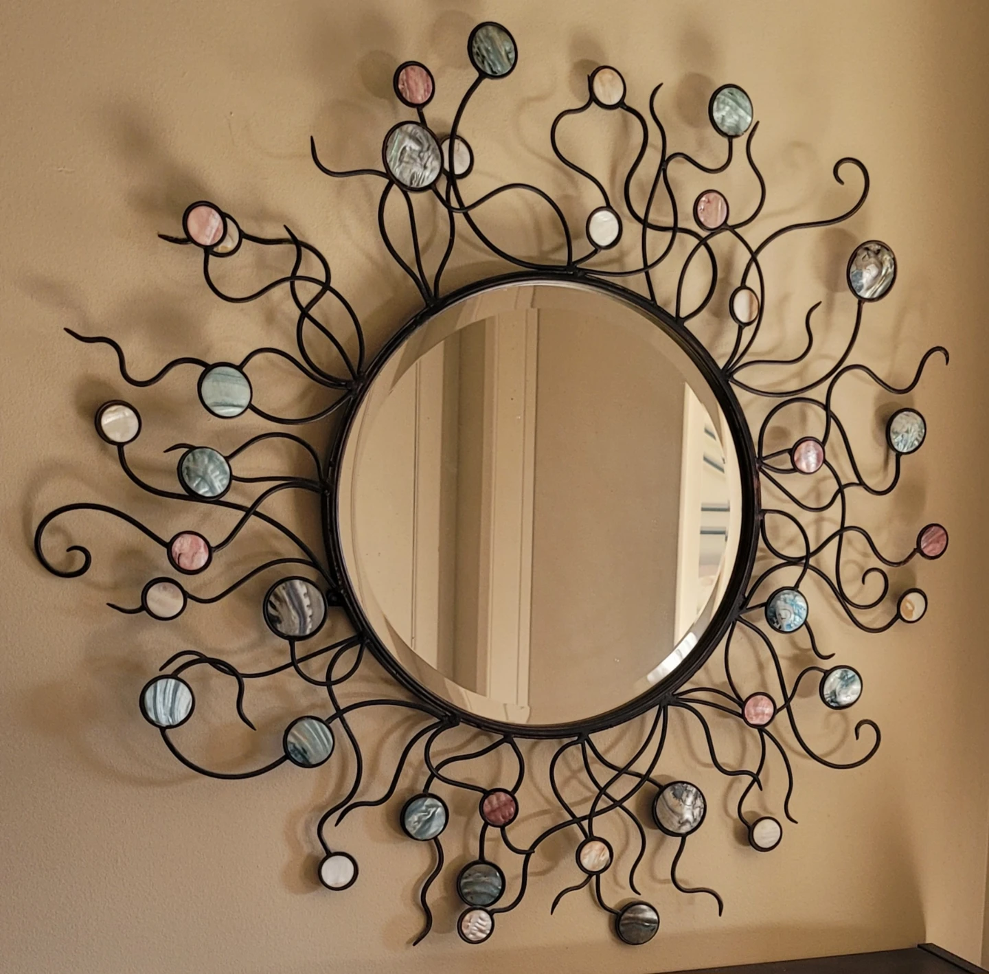 Decorative Sunburst Mirror with Blue and Pink Accents
