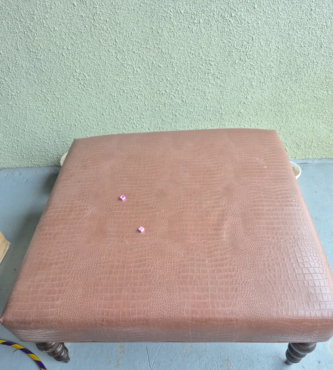 Large square brown ottoman – approx. 3 × 3 ft, wooden legs.