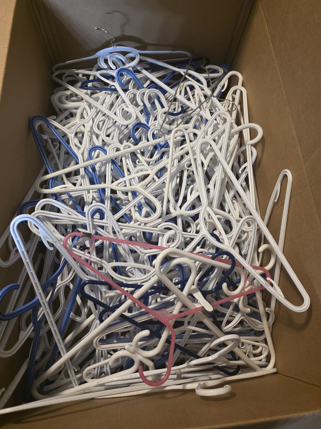 Bulk lot of mixed colour plastic clothes hangers