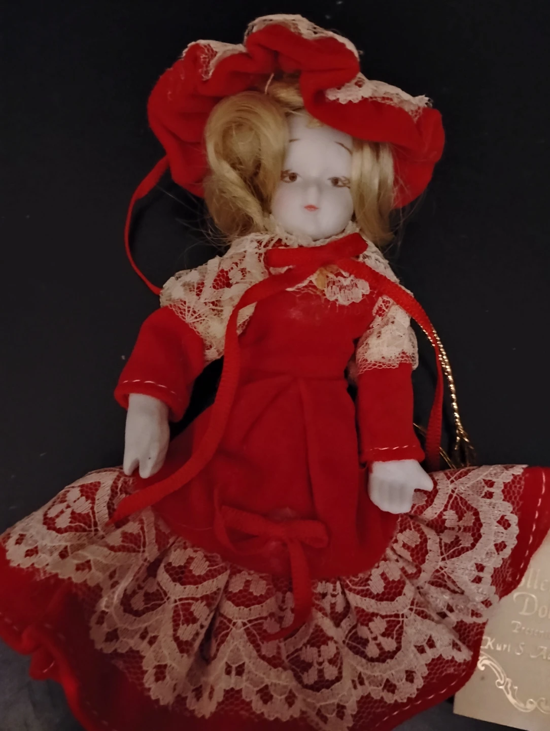 SMALL PORCELAIN GIRL DOLL IN A  RED VELVET DRESS W/ CREAM LACE