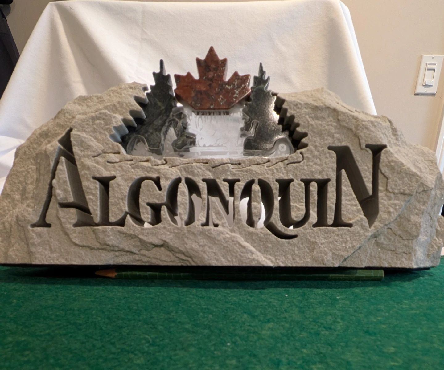 Algonquin Stone Carving with Maple Leaf and Canoe Scene
