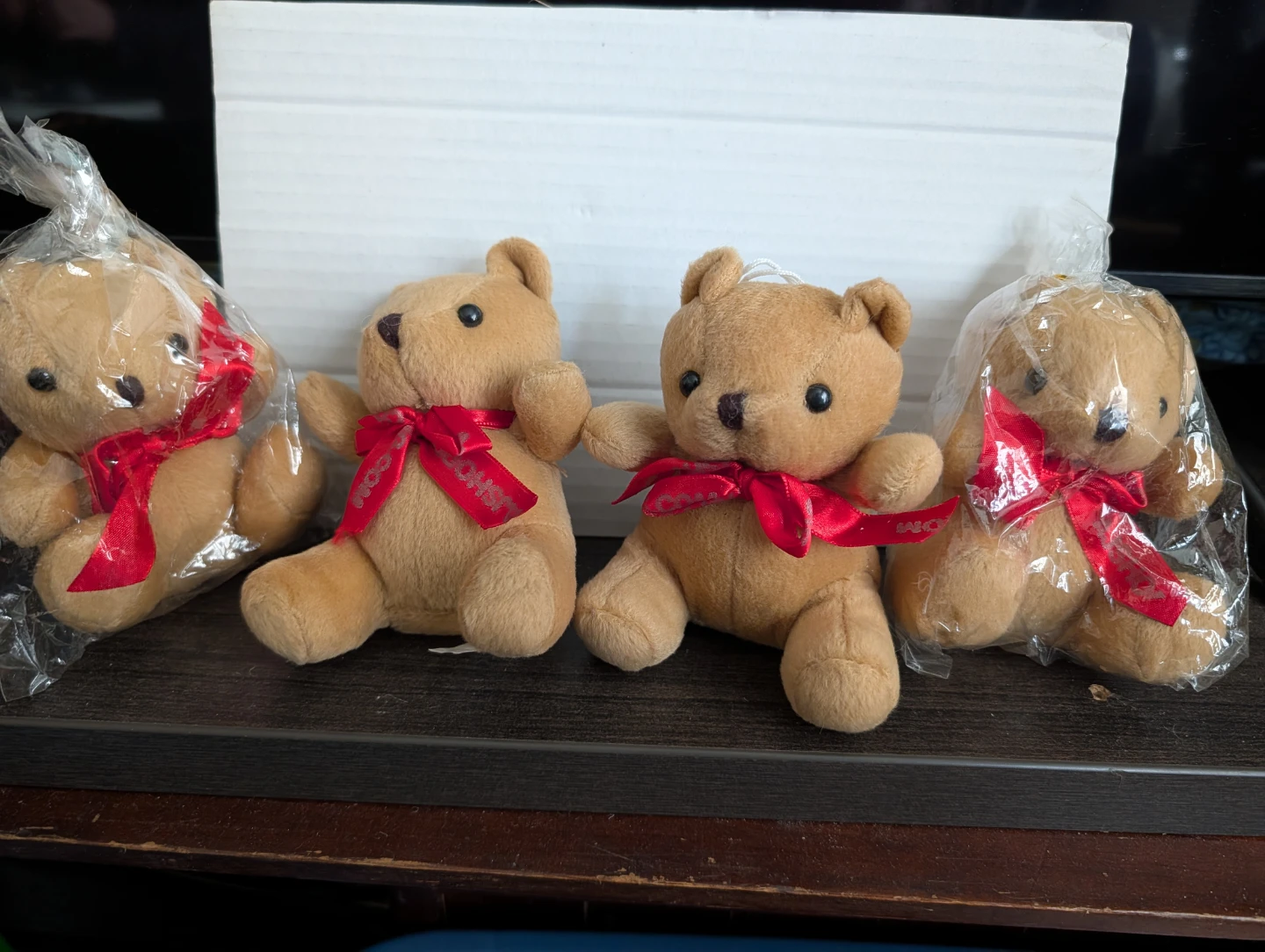 Four Small Teddy Bears with Red Ribbons