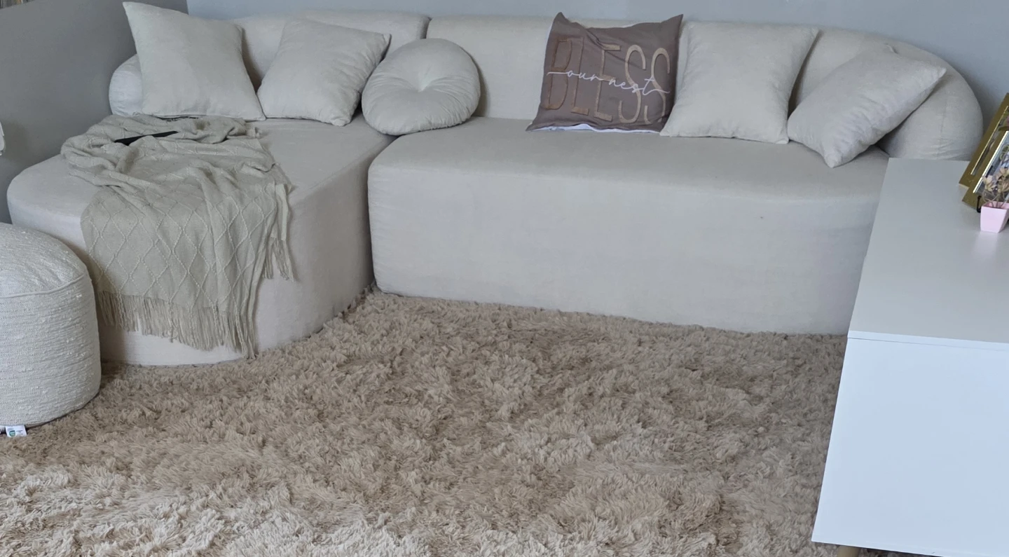 Cream Sectional Sofa with Ottoman and Throw Blanket