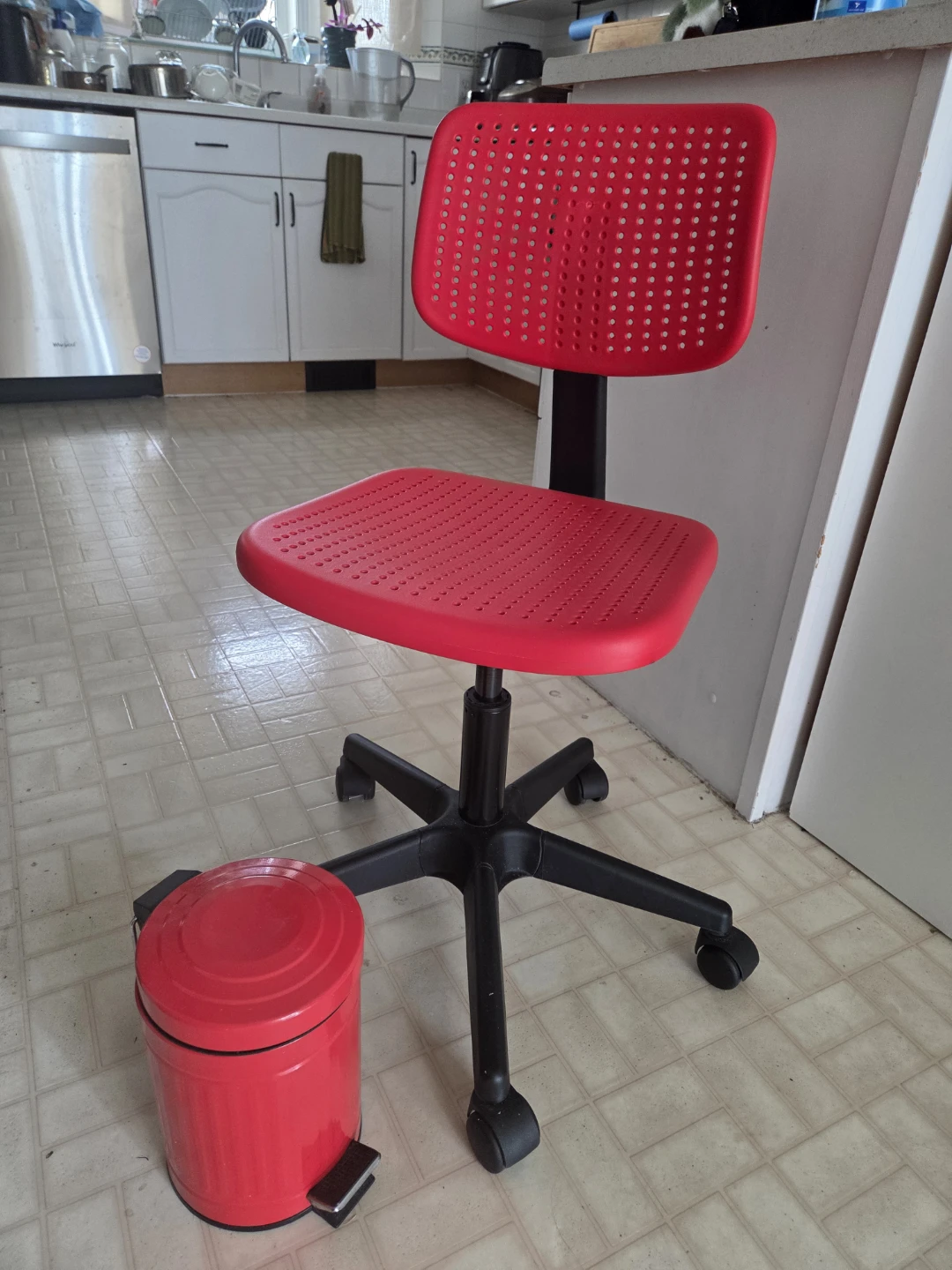 Red Office Chair and Pedal Step Trash Can