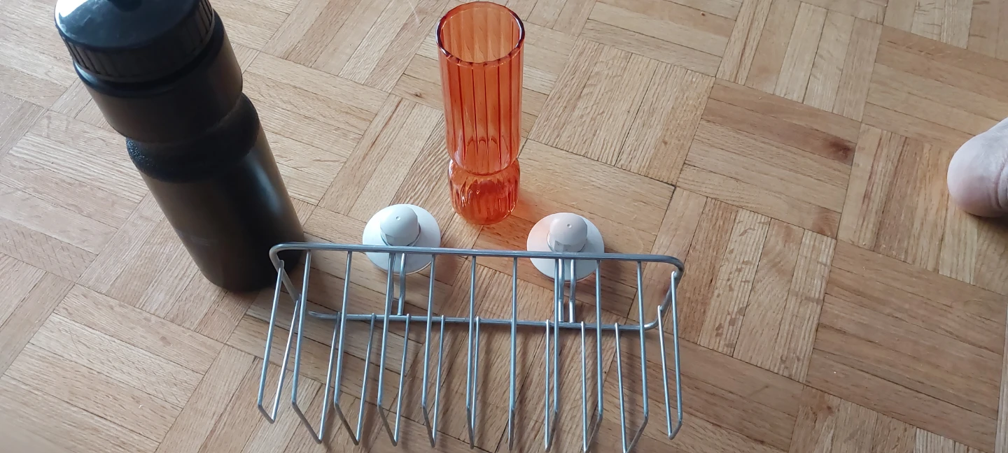Black Water Bottle with Metal Shower Caddy and Orange Tumbler