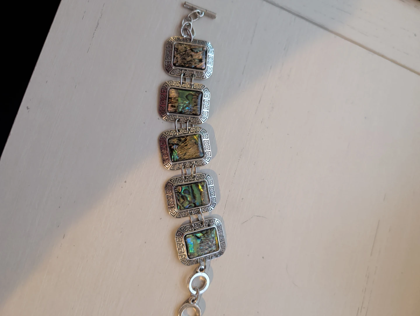 Silver tone bracelet with abalone shell inlays