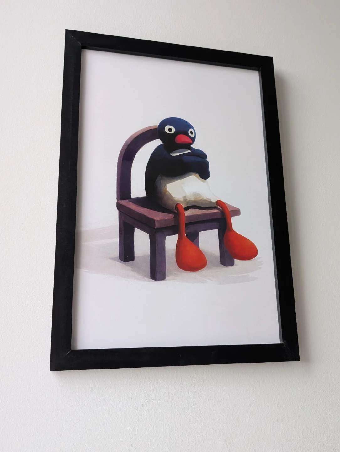 Framed 35x50cm upset Pingu sitting on a chair print - photo 3