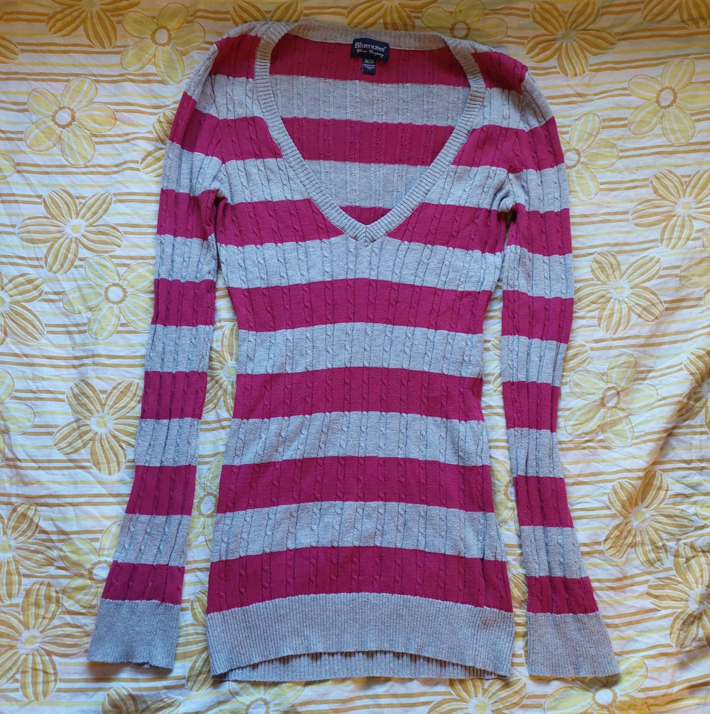 Pink and grey striped sweater with a V-neckline