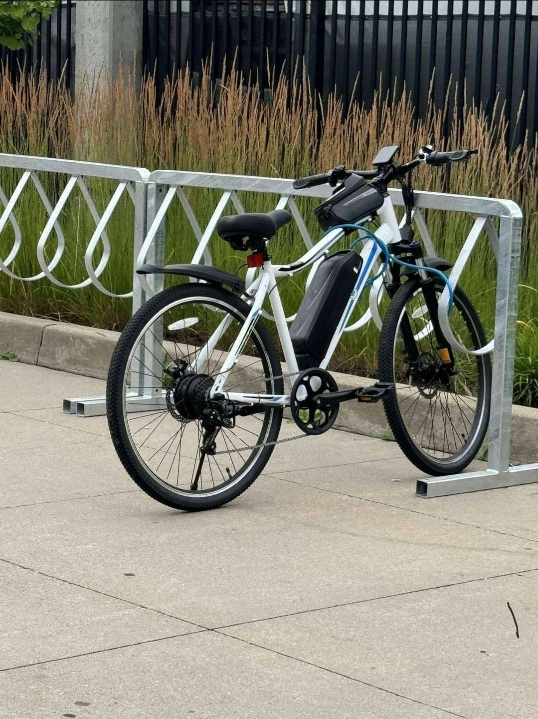 White Electric Bike with Black Battery Pack and Accessories