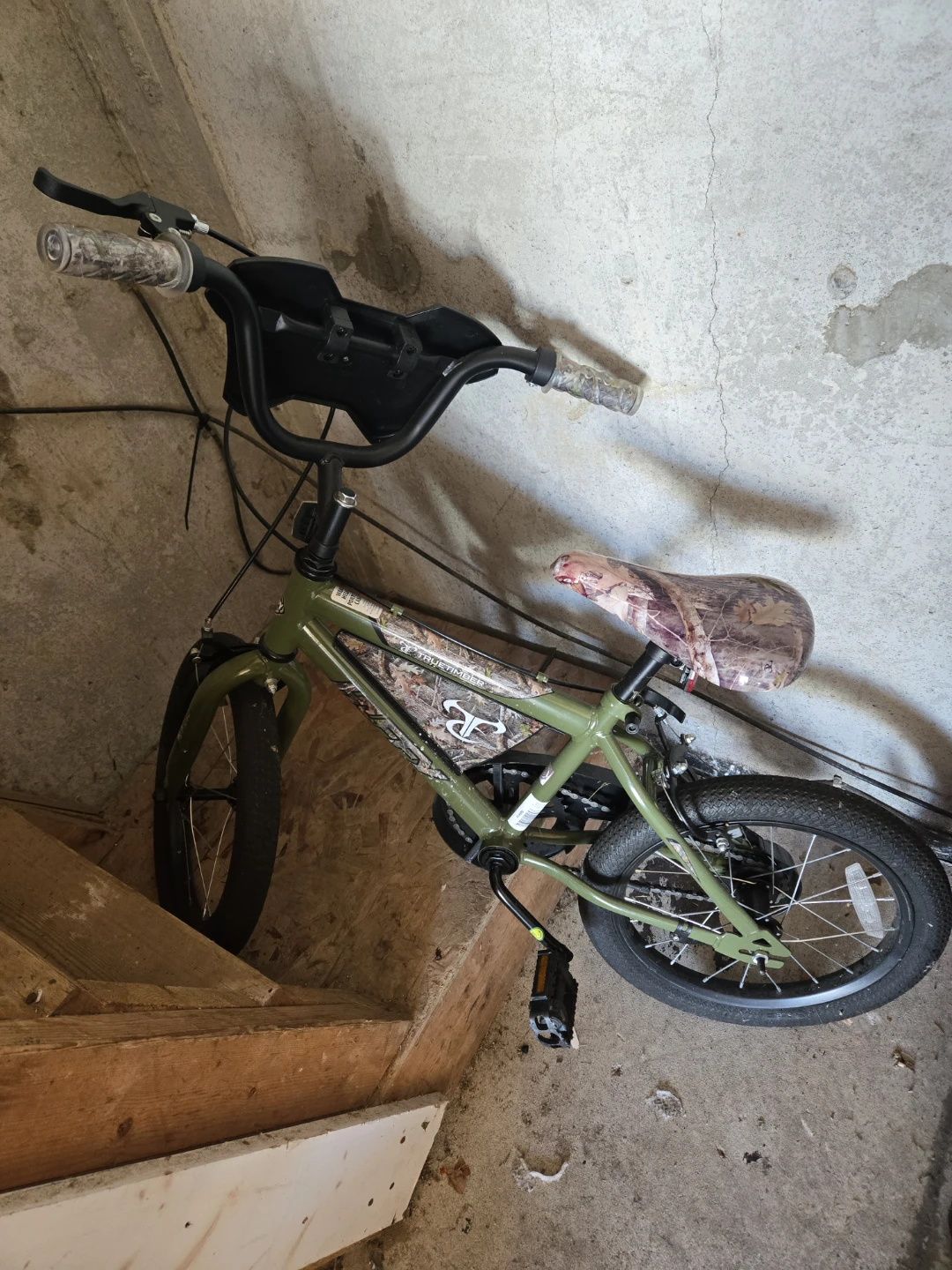 Green BMX Bike with Camouflage Seat and Handlebars