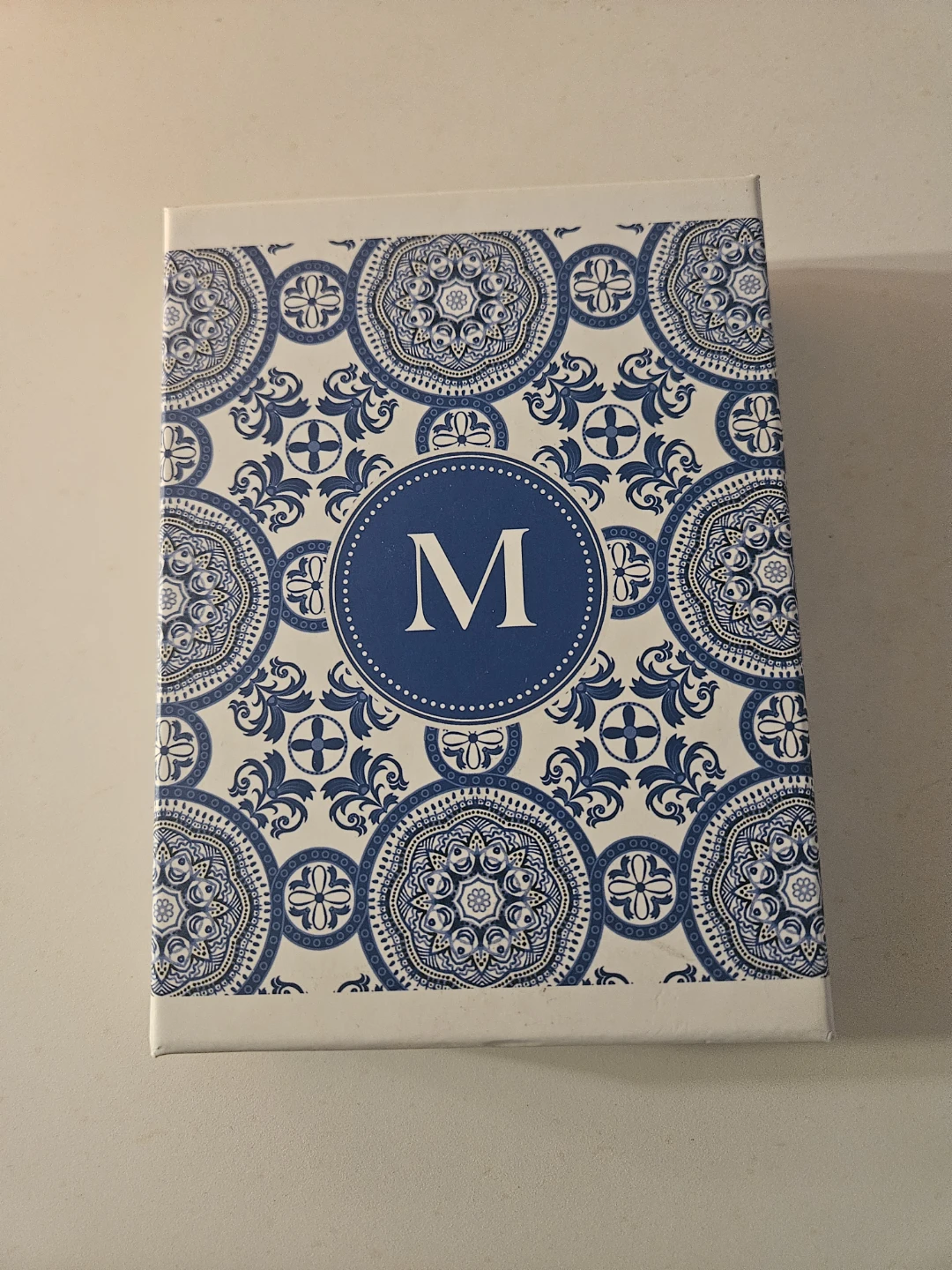 Box with cards with "M" decoration and envelopes