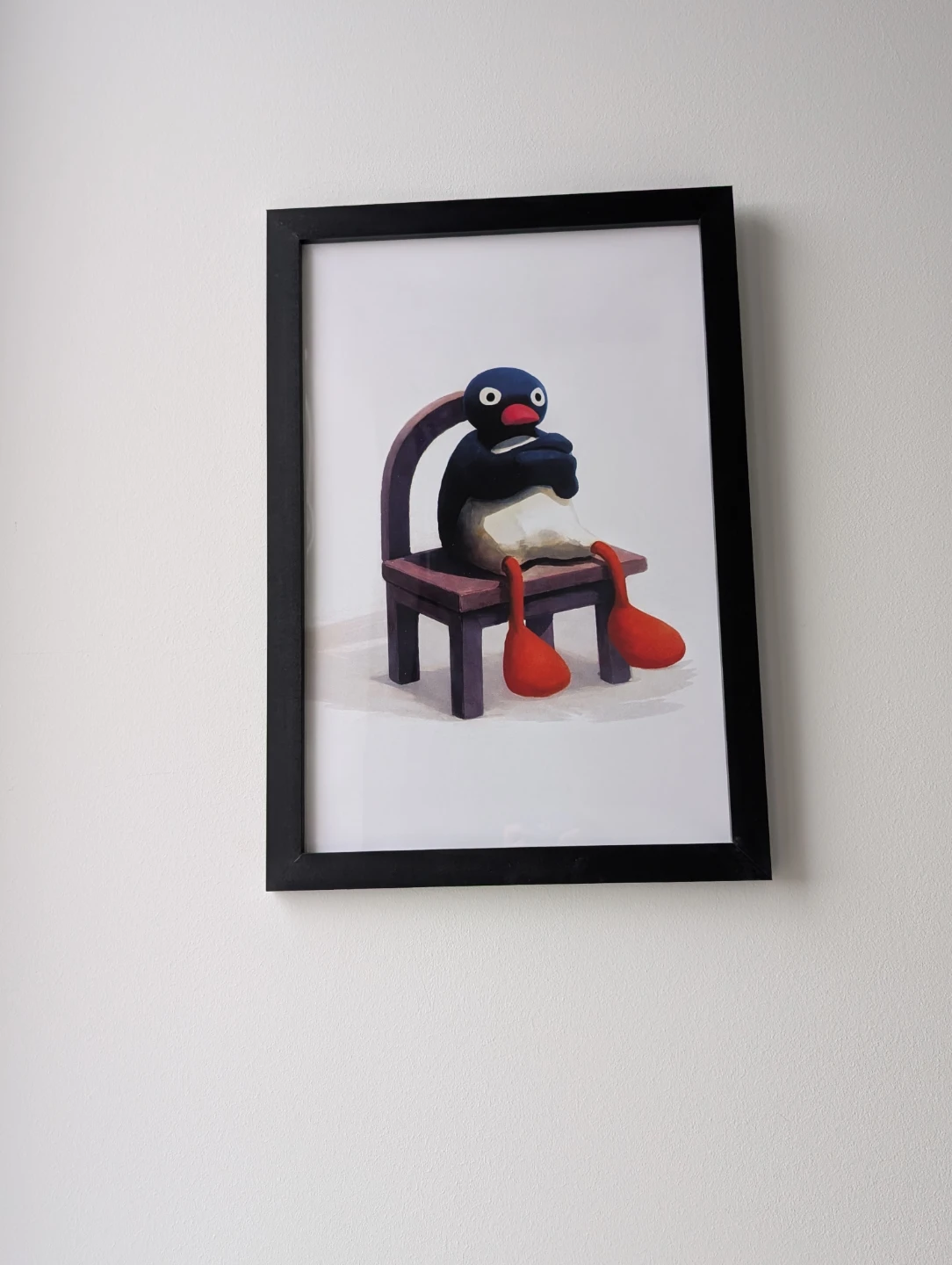 Framed 35x50cm upset Pingu sitting on a chair print - photo 2