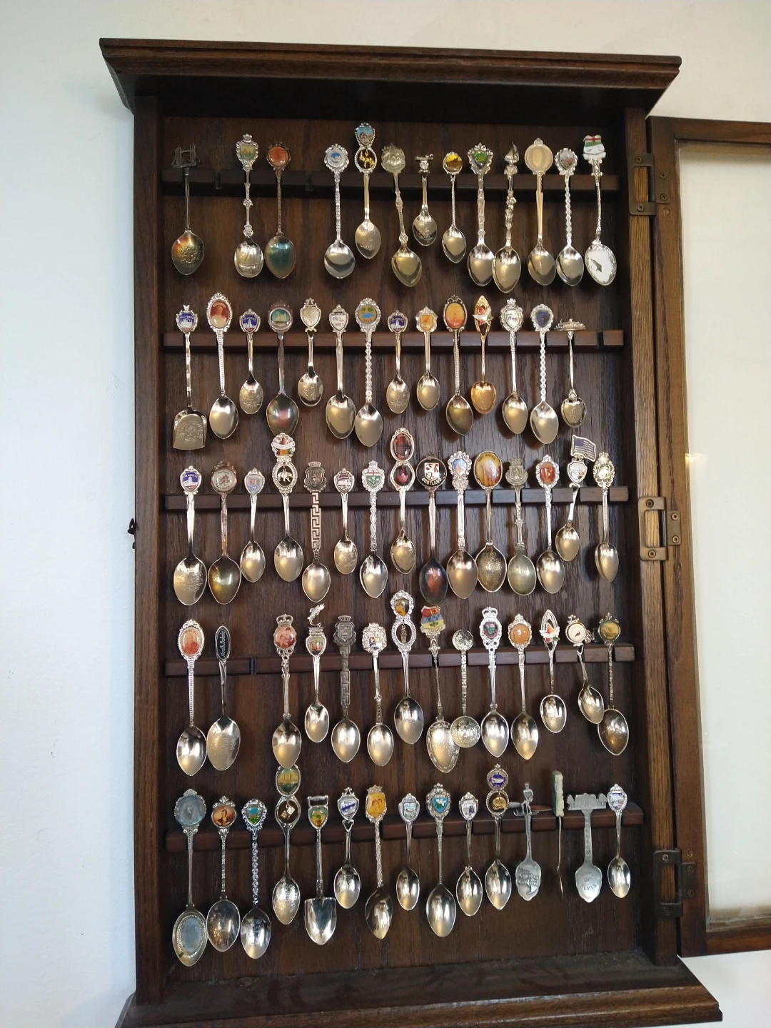 Collection of Souvenir Spoons in Display Case
