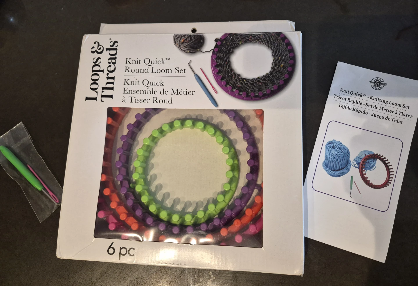 Knit quick round loom set along with black yarn