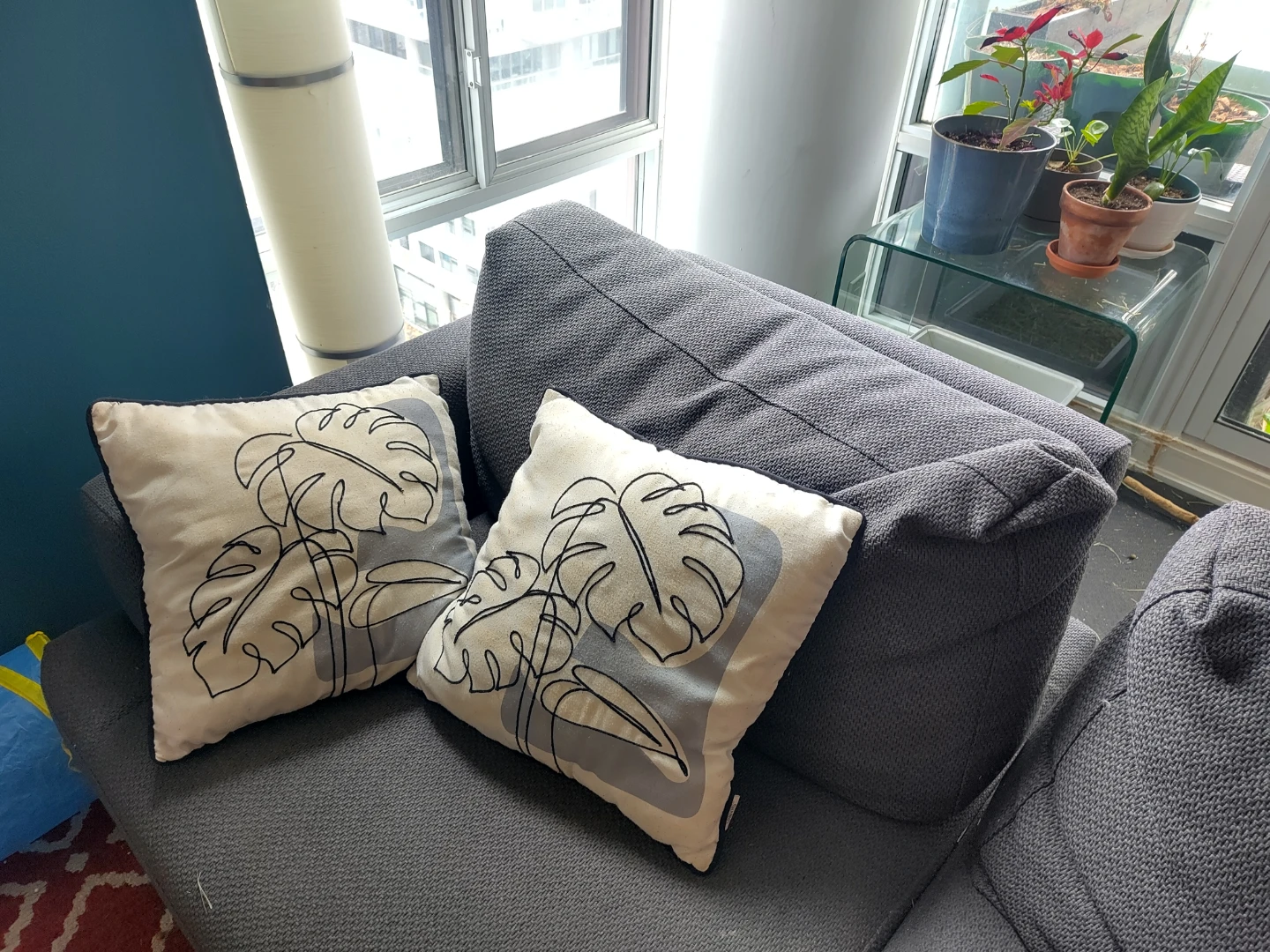 Two black and off-white leaf throw pillows