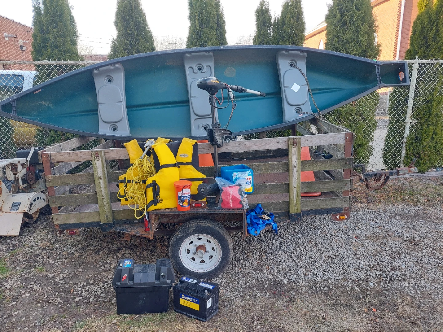 Green Canoe with Trolling Motor and Accessories