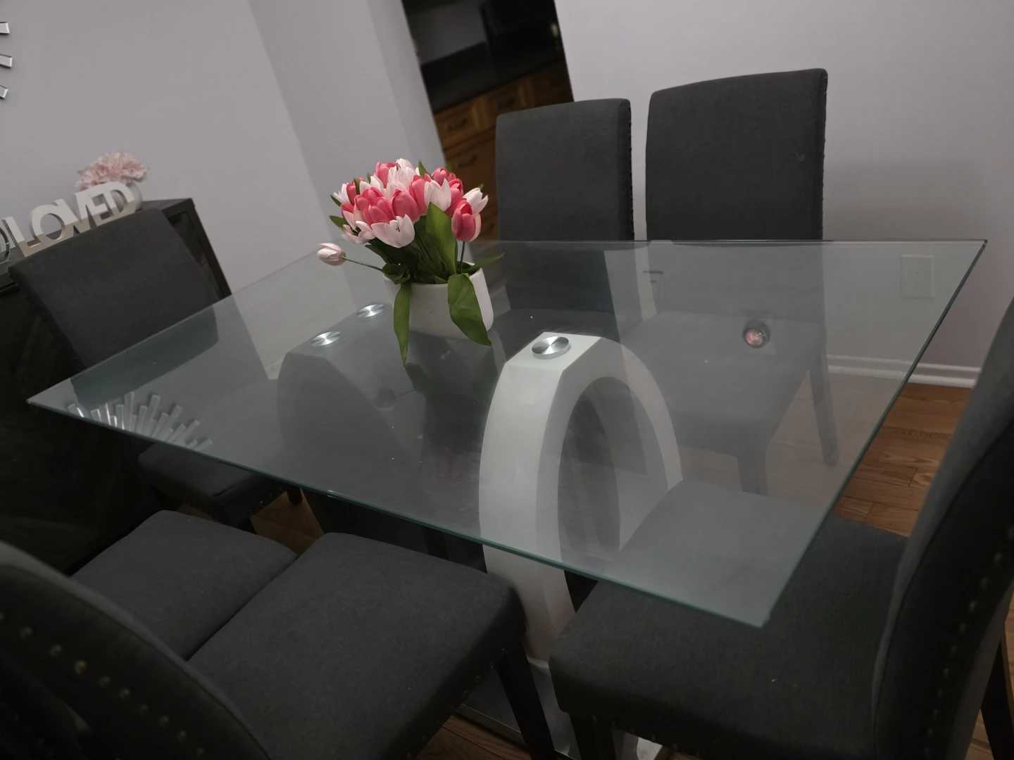 A glass dinning table with 6 chairs for sale.